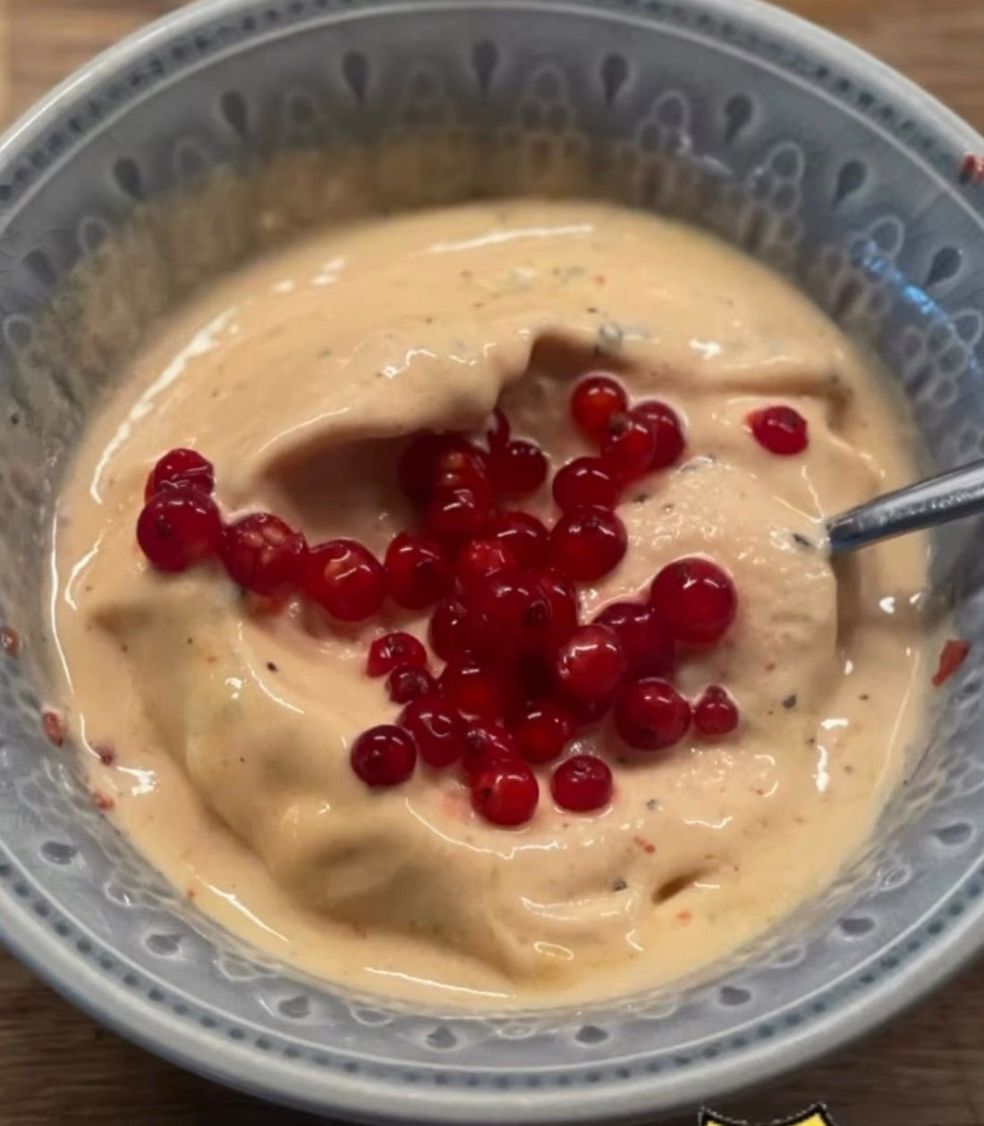 Rosa nice cream med mango, jordgubb och passionsfrukt toppad med röda vinbär i en skål